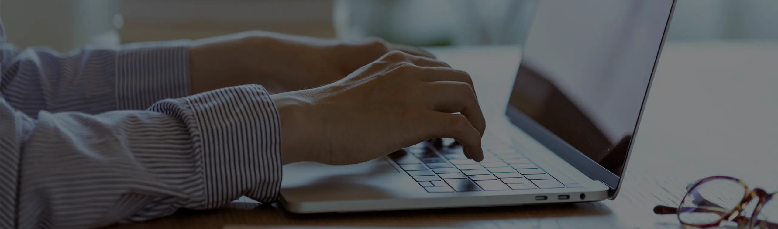 ノートパソコンで問い合わせを行おうとする人の手元